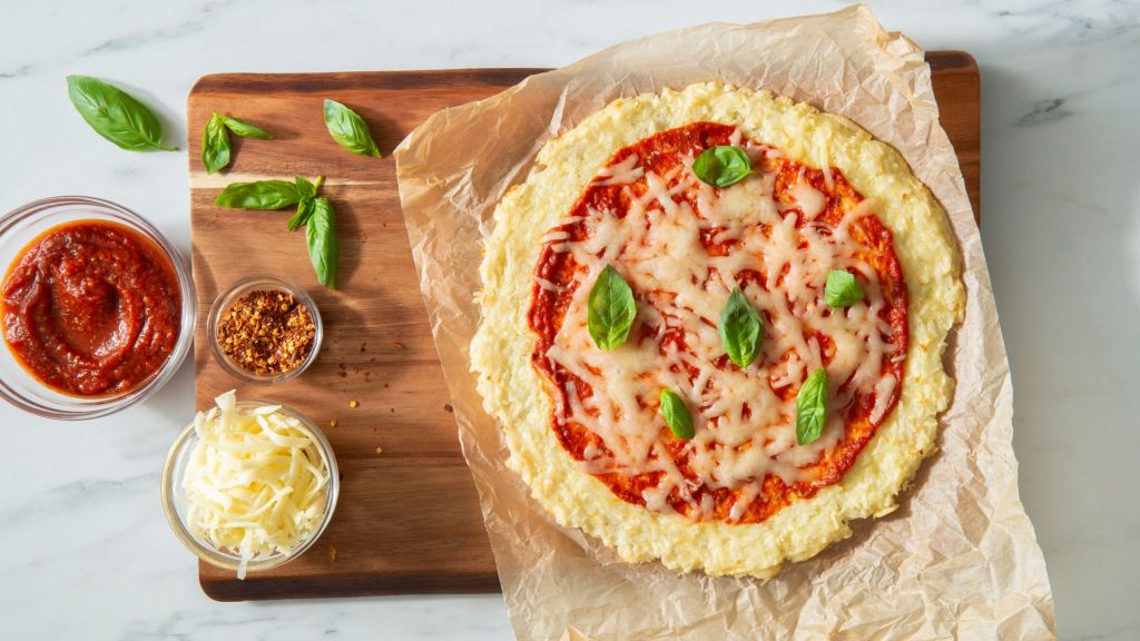 Gluten-Free-rice-crust-pizza-made-with-white-rice-and-topped-with-pizza-sauce-cheese-and-basil