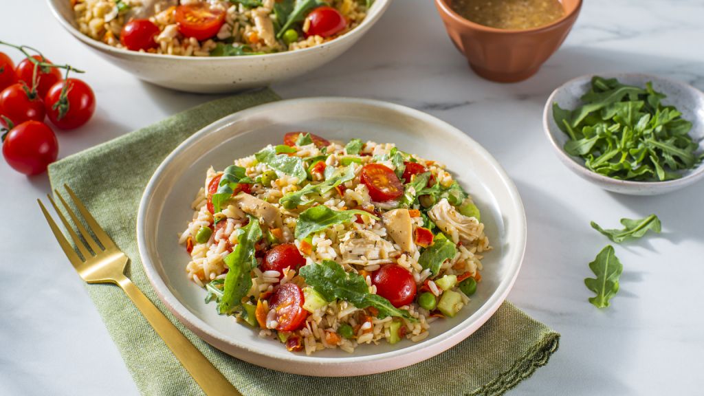 chicken-and-rice-salad-bowl-with-arugula-cherry-tomatoes-celery-and-bottled-vinaigrette-